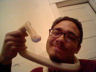 Me with my then-roommate’s albino cornsnake. Manda is still kickin’, and still as adorbs.
